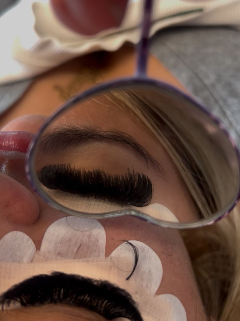 Lash set seen in a heart-shaped mirror