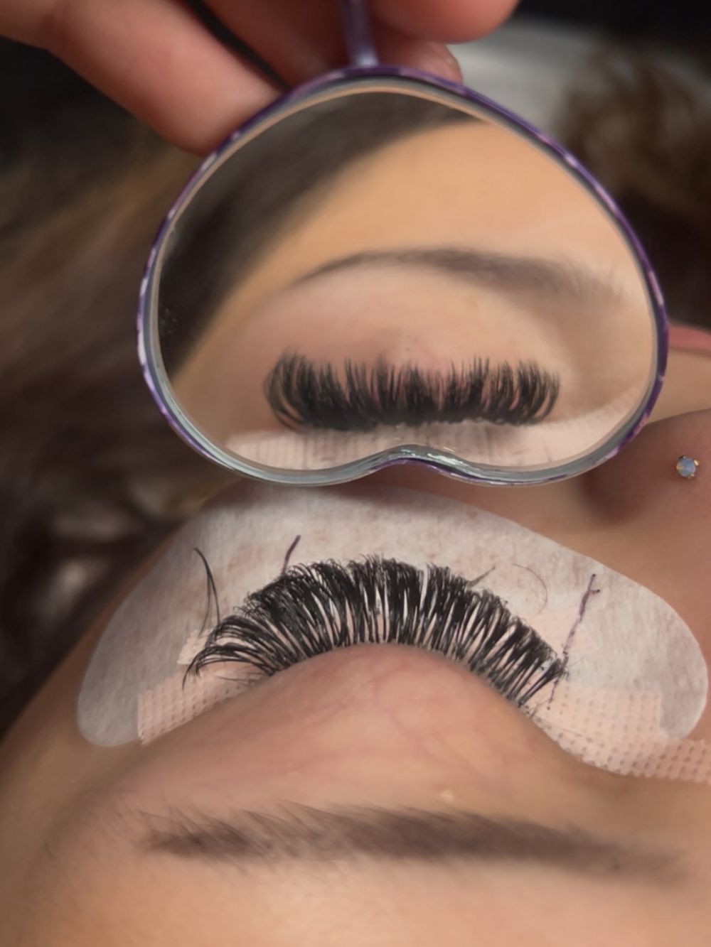 Wispy lash set next to a heart mirror