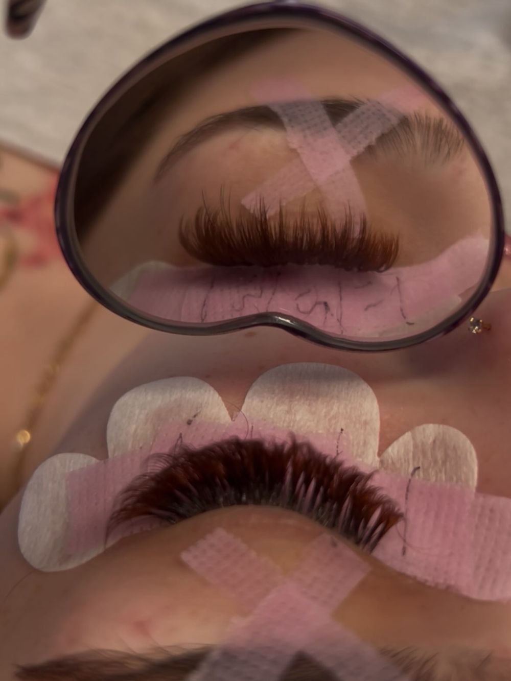Brown lash set under a heart mirror